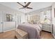 Inviting main bedroom with a decorative headboard, natural light, and an ensuite bathroom at 1212 Windy Bluff Dr, Minneola, FL 34715