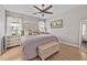 Serene main bedroom with a ceiling fan, accent wall, and natural light from the windows at 1212 Windy Bluff Dr, Minneola, FL 34715