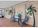 Relaxing outdoor patio space with seating and decorative palm trees at 1212 Windy Bluff Dr, Minneola, FL 34715