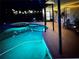 Inviting backyard pool with spa and illuminated ambiance perfect for evening relaxation and outdoor entertaining at 1212 Windy Bluff Dr, Minneola, FL 34715