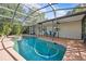 Beautiful screened pool with attached jacuzzi and outdoor seating area perfect for relaxation and entertaining at 1212 Windy Bluff Dr, Minneola, FL 34715
