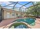 Inviting swimming pool and jacuzzi with a screened enclosure at 1212 Windy Bluff Dr, Minneola, FL 34715