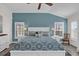 Primary bedroom showcasing tray ceiling, plantation shutters, and an accent wall, creating an inviting and serene space at 1263 Eureka Mill Run, The Villages, FL 32162