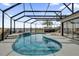 Enclosed pool with a waterfall feature and beautiful views of the serene lake at 1263 Eureka Mill Run, The Villages, FL 32162