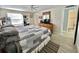 Cozy bedroom features wood floors, a ceiling fan, and a window for natural light at 127 Hibiscus Way, Leesburg, FL 34748