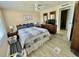 Bedroom with a comfortable bed, ceiling fan, and access to other rooms at 127 Hibiscus Way, Leesburg, FL 34748