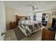 Inviting bedroom with a cozy quilt, ceiling fan, and ample storage space at 127 Hibiscus Way, Leesburg, FL 34748