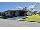 Charming single-story home with well-maintained landscaping and covered parking at 127 Hibiscus Way, Leesburg, FL 34748