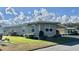 Well-kept single-story home with a neat lawn and convenient covered parking at 127 Hibiscus Way, Leesburg, FL 34748