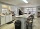 Spacious kitchen with a large island and stainless steel appliances at 127 Hibiscus Way, Leesburg, FL 34748