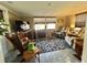 Comfortable living room with tile floors, plush seating, and a large television, perfect for relaxation at 127 Hibiscus Way, Leesburg, FL 34748