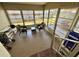 Enclosed sunroom featuring plenty of natural light and tile flooring at 127 Hibiscus Way, Leesburg, FL 34748