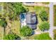 Bird's eye view of the home with a private pool, patio area, and expansive green lawn at 12802 Amber Ave, Clermont, FL 34711