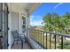 Balcony with black metal railing and a peaceful view of the trees and a glimpse of the lake at 12802 Amber Ave, Clermont, FL 34711