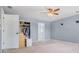 Bedroom with carpet flooring, ceiling fan, closet, and blue walls at 12802 Amber Ave, Clermont, FL 34711