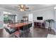 Dining room with hardwood floors and large windows to the kitchen and living area at 12802 Amber Ave, Clermont, FL 34711