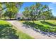 Sprawling home with a long driveway, lush landscaping, and attached garage at 12802 Amber Ave, Clermont, FL 34711