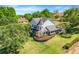 Aerial view of a beautiful two-story home with mature trees and meticulous landscaping at 12802 Amber Ave, Clermont, FL 34711