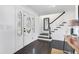 Elegant foyer with dark wood floors, staircase, and stained glass front door at 12802 Amber Ave, Clermont, FL 34711