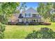 Inviting two-story home featuring a covered front porch and lush landscaping at 12802 Amber Ave, Clermont, FL 34711