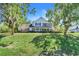 Stately home with a covered porch, mature trees, and a spacious front yard at 12802 Amber Ave, Clermont, FL 34711