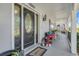 Charming front porch with decorative door, potted plants, and seating, creating a welcoming entrance at 12802 Amber Ave, Clermont, FL 34711
