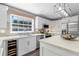 Stylish kitchen featuring stainless appliances, white cabinetry, quartz counters, and modern lighting at 12802 Amber Ave, Clermont, FL 34711
