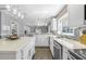 Open kitchen with stainless steel appliances, stone backsplash, and ample countertop space at 12802 Amber Ave, Clermont, FL 34711