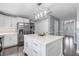 Bright kitchen featuring a large island, stainless appliances, and modern pendant lighting at 12802 Amber Ave, Clermont, FL 34711