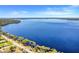 Expansive aerial view of a pristine lake, showing the waterfront area and surrounding natural beauty at 12802 Amber Ave, Clermont, FL 34711