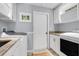 Convenient laundry room equipped with granite counters, cabinets and appliances at 12802 Amber Ave, Clermont, FL 34711