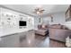 Inviting living room featuring built-in shelving, ceiling fan, and comfortable seating at 12802 Amber Ave, Clermont, FL 34711