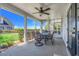 Screened patio featuring brick flooring, a ceiling fan, and patio furniture with views of the backyard at 12802 Amber Ave, Clermont, FL 34711