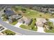 Overhead view of this home's manicured lot, set against the backdrop of a beautiful golf course at 13146 Se 91St Court Rd, Summerfield, FL 34491