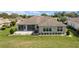 Expansive backyard featuring a screened lanai, lush lawn and mature landscaping around the house at 13146 Se 91St Court Rd, Summerfield, FL 34491