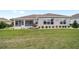 Lovely backyard with a screened-in patio, manicured lawn, and meticulous landscaping at 13146 Se 91St Court Rd, Summerfield, FL 34491