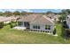 Scenic backyard showcases a screened-in porch, well-kept lawn, and meticulous landscaping elements at 13146 Se 91St Court Rd, Summerfield, FL 34491