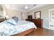 Primary bedroom boasting tray ceilings, wood floors, and large windows for natural light at 13146 Se 91St Court Rd, Summerfield, FL 34491