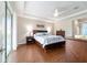 Primary bedroom featuring wood floors, tray ceiling, and a comfortable, well-lit space at 13146 Se 91St Court Rd, Summerfield, FL 34491
