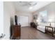 Bedroom featuring wood flooring, a ceiling fan, closet, and a window offering natural light at 13146 Se 91St Court Rd, Summerfield, FL 34491