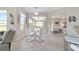 Open dining area with natural light from the windows and seamless access to the screened-in porch at 13146 Se 91St Court Rd, Summerfield, FL 34491