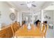 Dining room with elegant wood table, decor niche, and seamless flow into the living spaces at 13146 Se 91St Court Rd, Summerfield, FL 34491