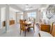 Bright dining room showcases wood furniture, tile flooring, and open access to entry hall at 13146 Se 91St Court Rd, Summerfield, FL 34491