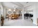 Bright dining room with a grand wood table set and a view into the living room area at 13146 Se 91St Court Rd, Summerfield, FL 34491