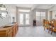 Bright foyer with tile floors and natural light, featuring a decorative mirror and dining area at 13146 Se 91St Court Rd, Summerfield, FL 34491