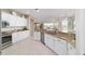 Bright kitchen features granite counters, stainless steel appliances, and white cabinets at 13146 Se 91St Court Rd, Summerfield, FL 34491