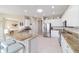 Bright kitchen features granite counters, stainless steel appliances, and barstool seating at 13146 Se 91St Court Rd, Summerfield, FL 34491