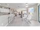 Open-concept kitchen and dining area with tile flooring and a view to the living room at 13146 Se 91St Court Rd, Summerfield, FL 34491