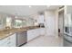 Bright kitchen features granite counters, white cabinets, and seamless flow to outdoor living areas at 13146 Se 91St Court Rd, Summerfield, FL 34491