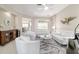 Bright living room with white seating, a piano, tile floors, and a ceiling fan at 13146 Se 91St Court Rd, Summerfield, FL 34491